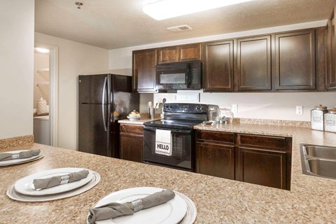 a kitchen with stainless steel appliances and granite counter tops