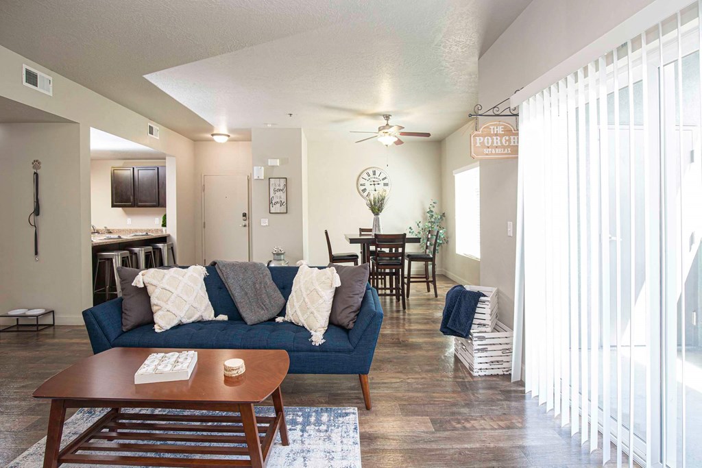 a living room with a blue couch and a coffee table