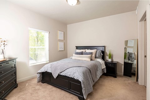 a bedroom with a large bed and two night stands