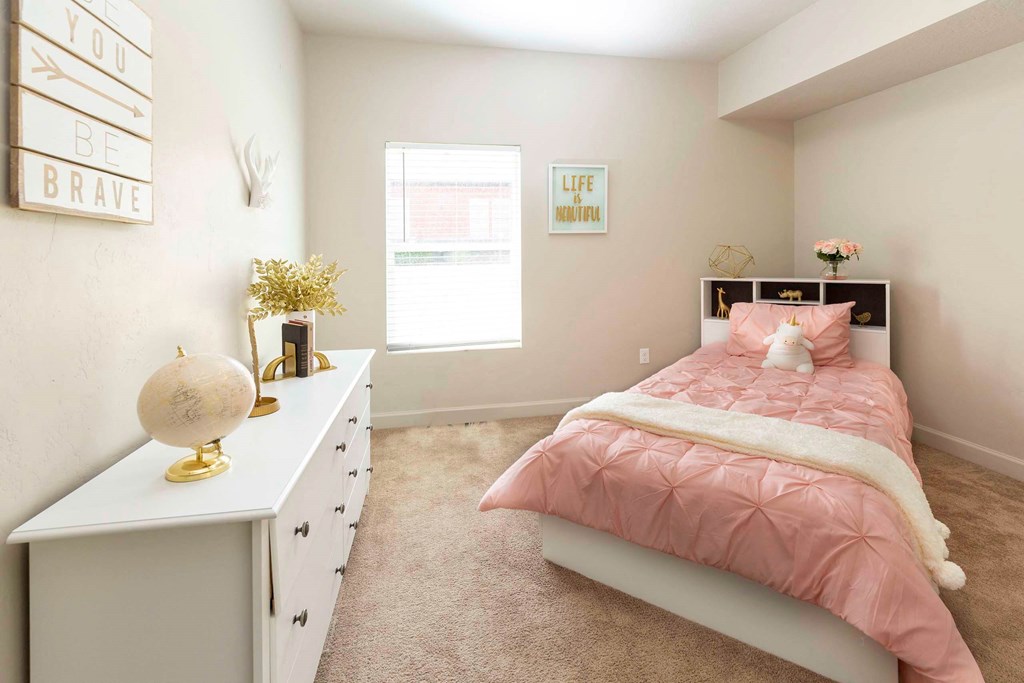 a bedroom with a bed and dresser