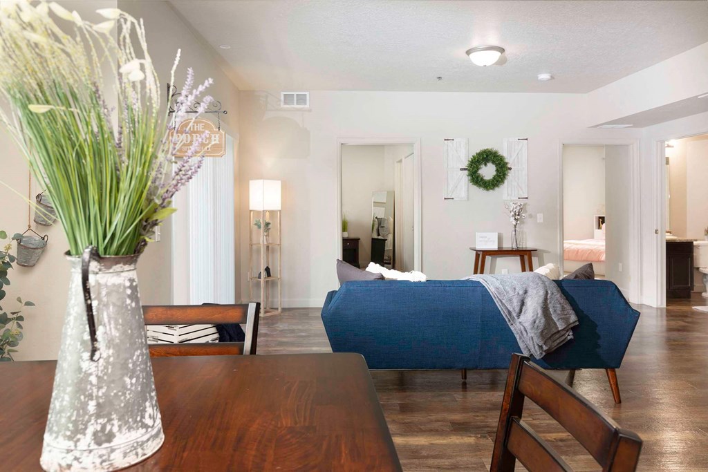 a bedroom with a bed and a table in a room