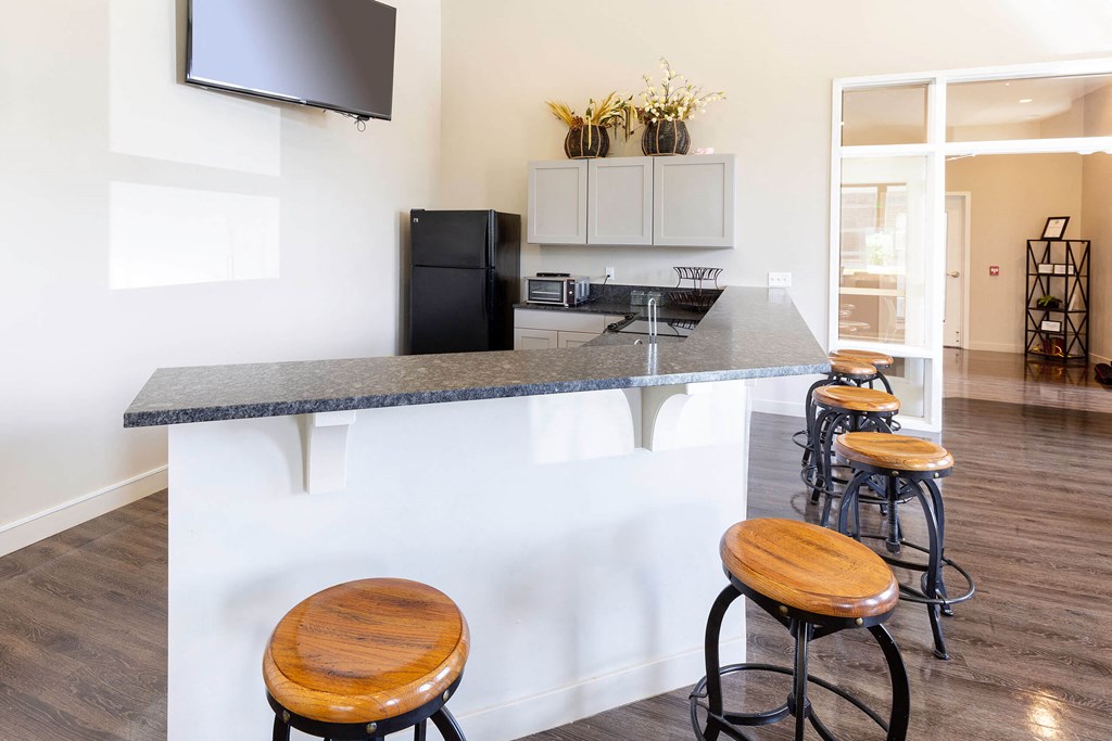a kitchen with a counter top and stools