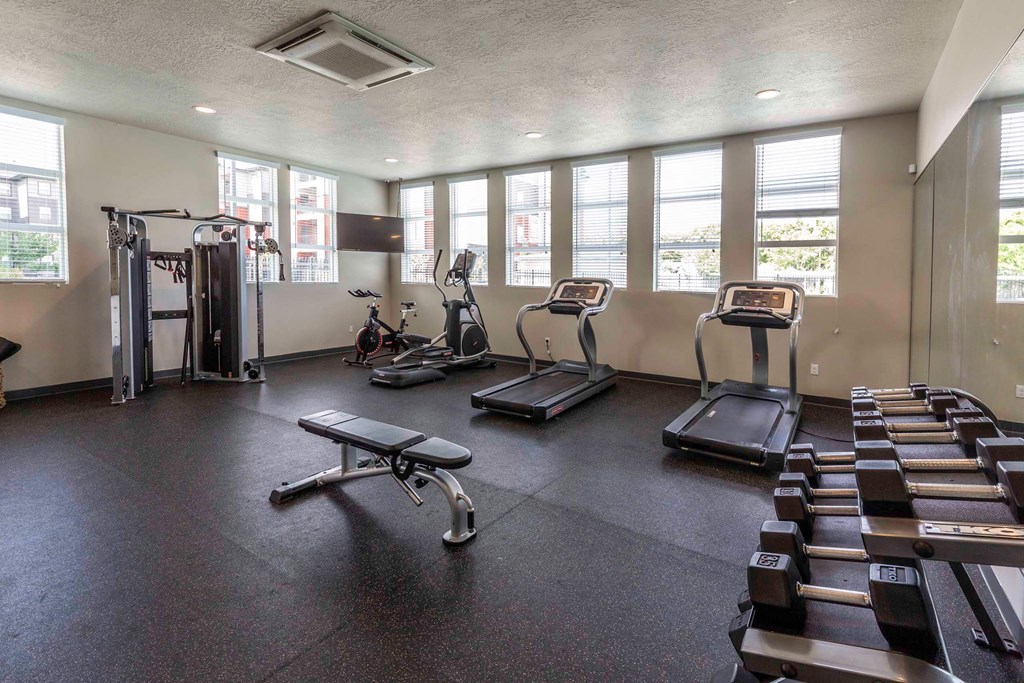 a gym with treadmills and other exercise equipment