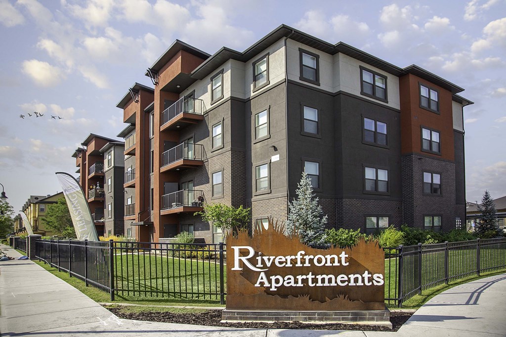 an apartment building with a sign that reads riverfront apartments