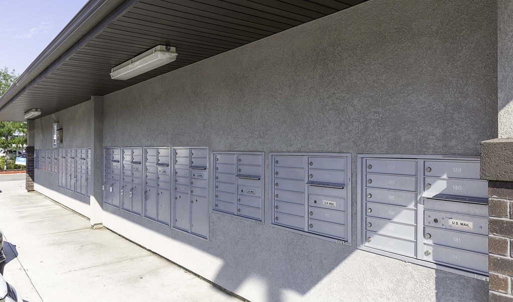 a picture of the side of a building with a bunch of mailboxes