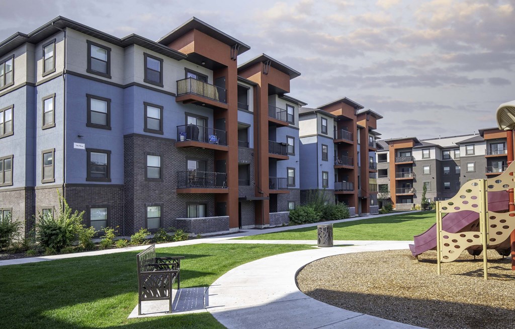 picture of an apartment building with a playground