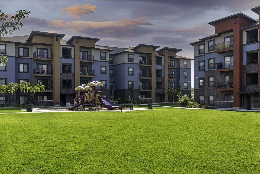 a playground at the flats at big tex apartments in san antonio, tx
