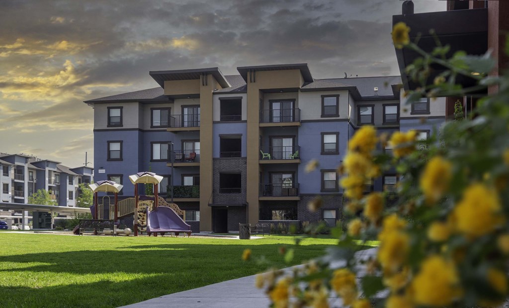a large building with a playground in front of it