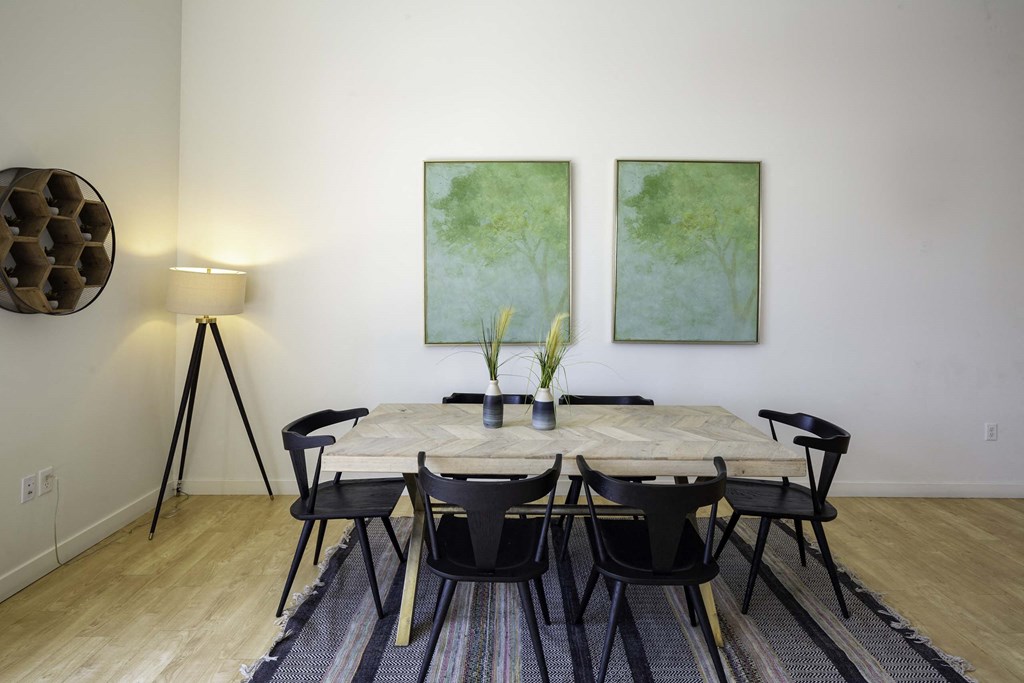 a dining room with two paintings on the wall