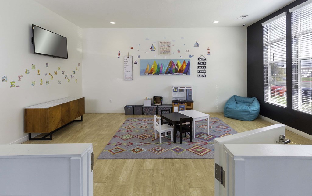 a room with a table and chairs and a flat screen tv on the wall