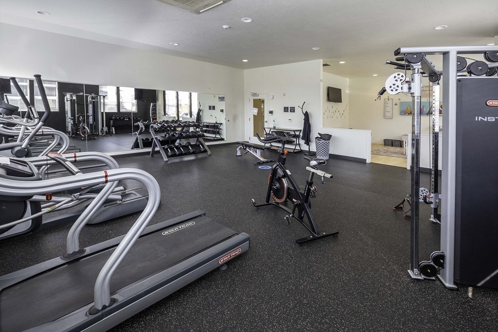 a room filled with lots of different types of exercise equipment