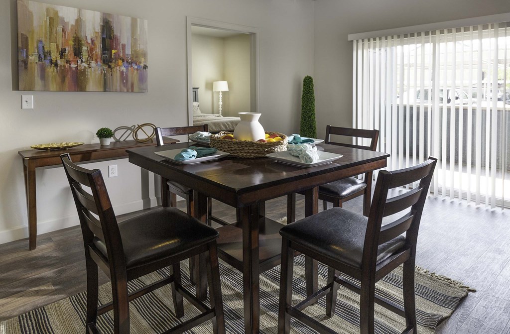a dining room with a table and chairs