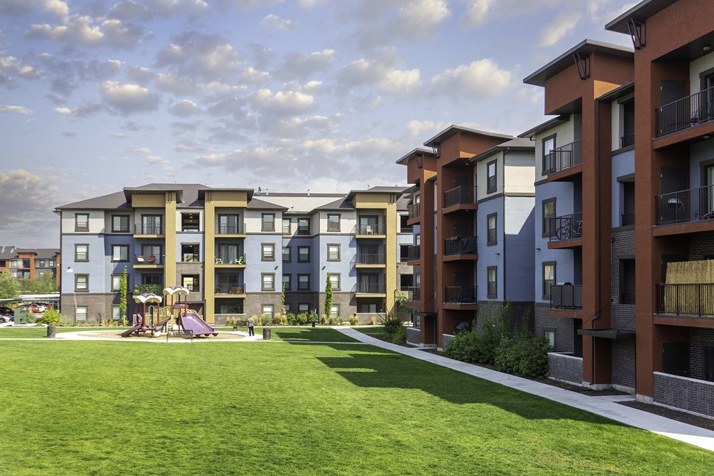 an exterior view of an apartment complex with a playground