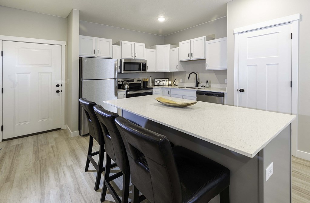 a kitchen with white cabinets and a white counter top