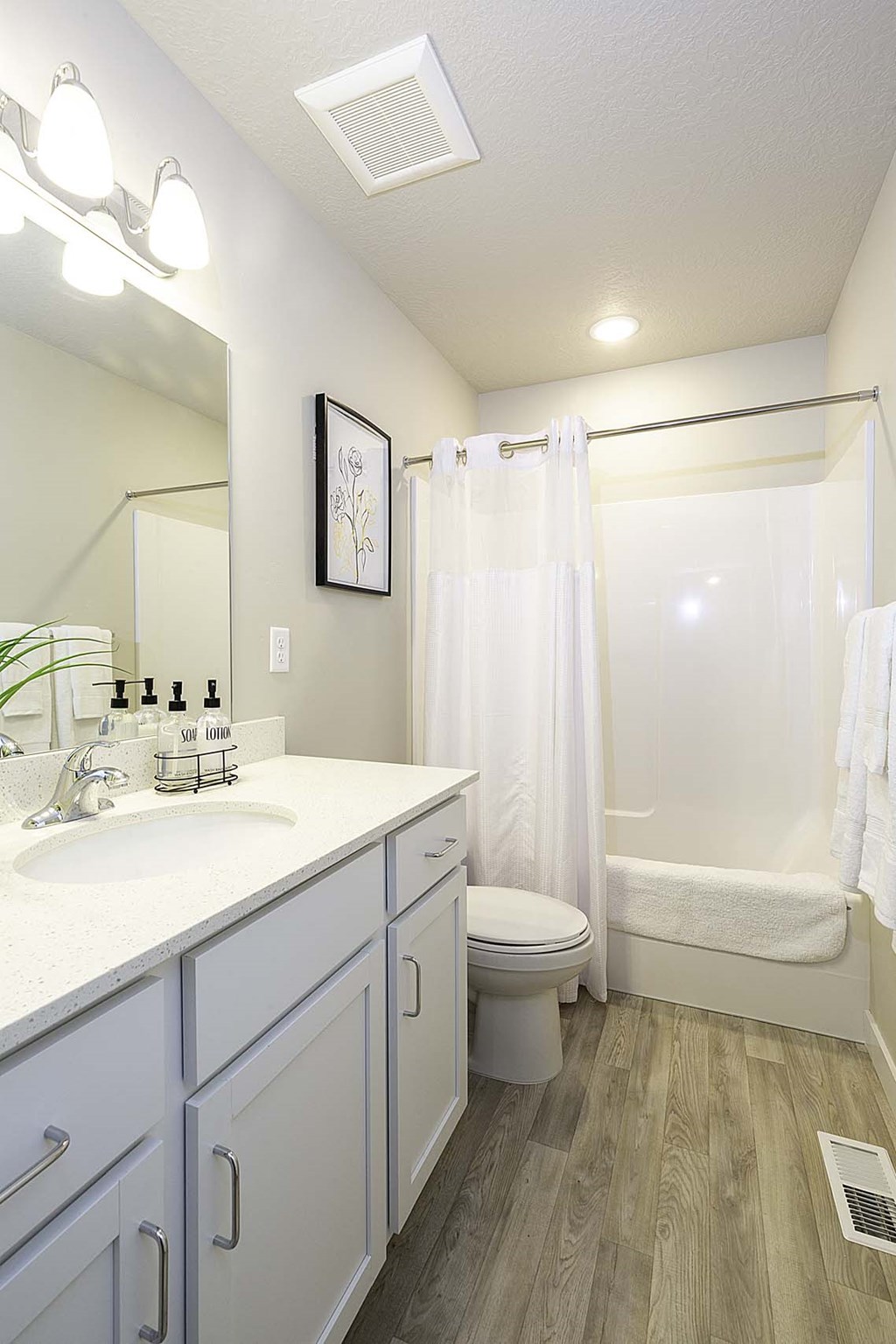 a bathroom with a toilet sink and shower