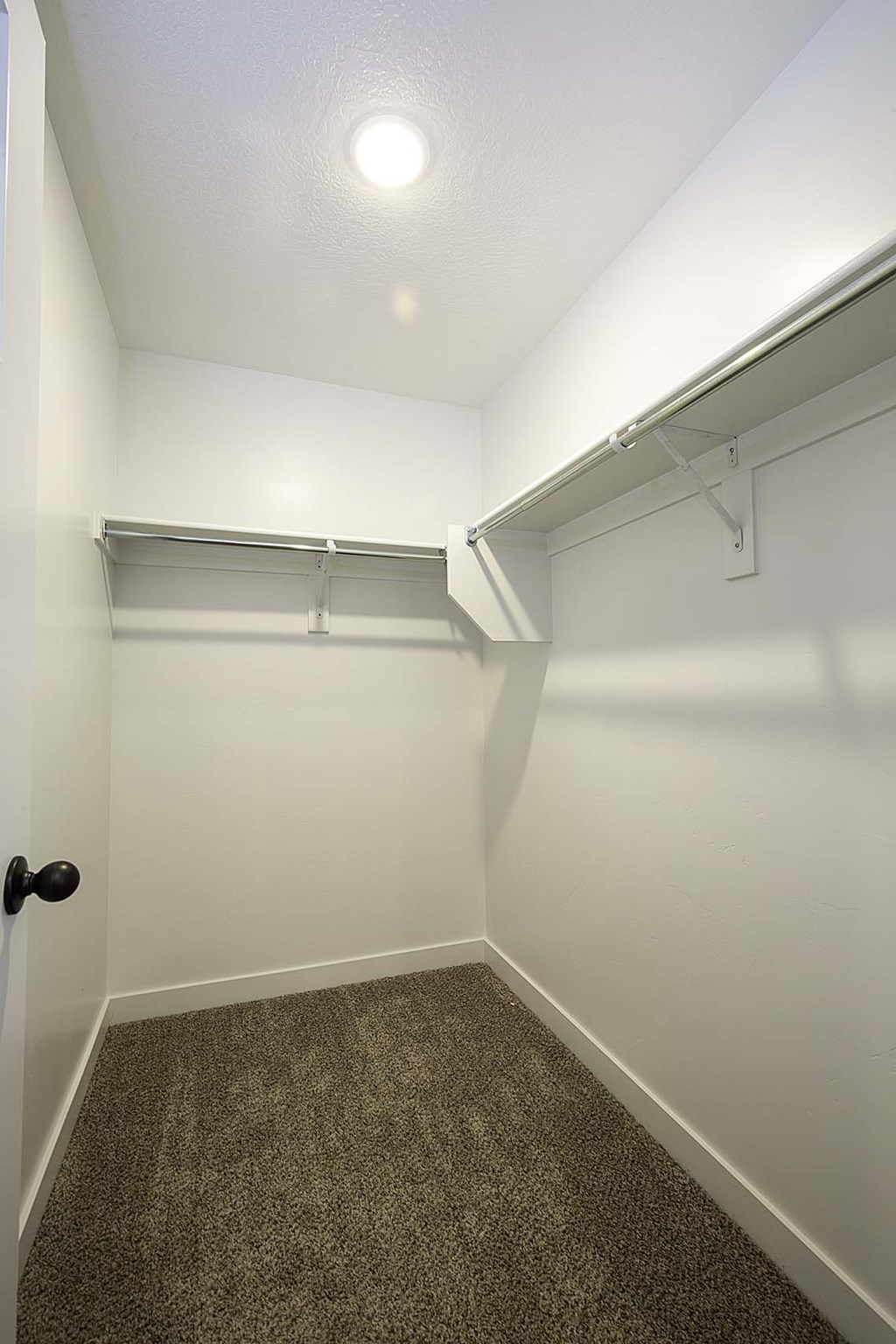 a walk in closet in a bedroom