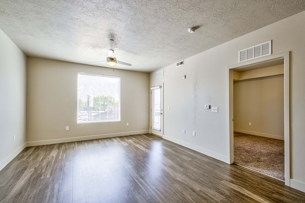 a bedroom with hardwood floors and a ceiling fan