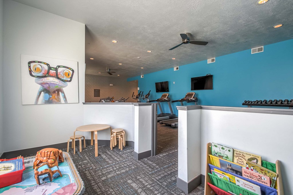 a room with a table and chairs and a wall with a painting