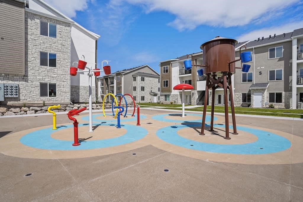 an empty playground in front of an apartment building