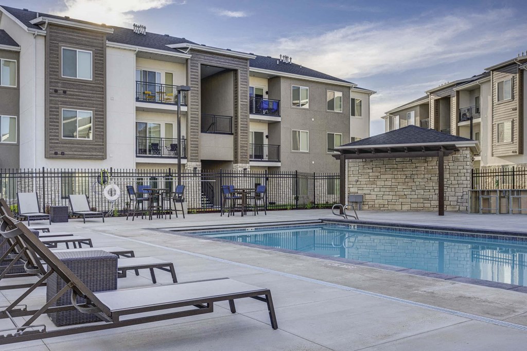 a swimming pool is next to an apartment building with a pool