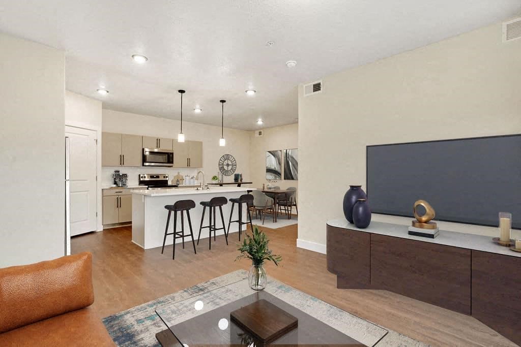 a kitchen and living room with a table and chairs