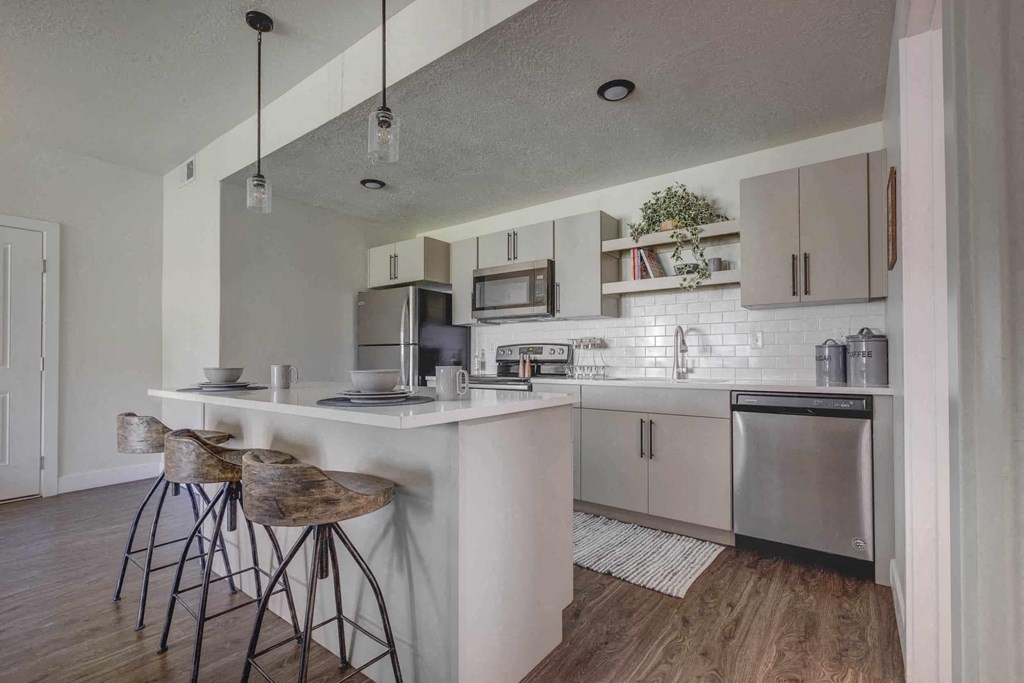 a kitchen with a counter and bar stools