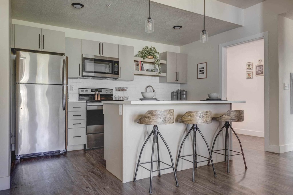 a kitchen with a counter and bar stools