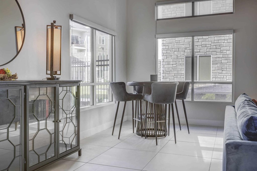 a dining room with a table and chairs and a window