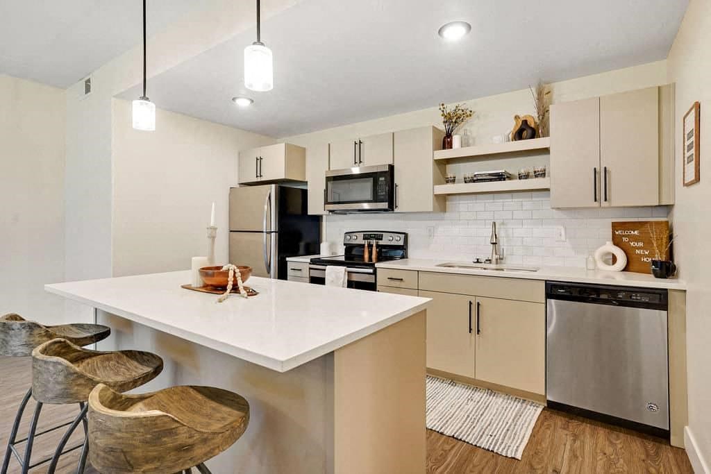 a kitchen with a counter top and a refrigerator