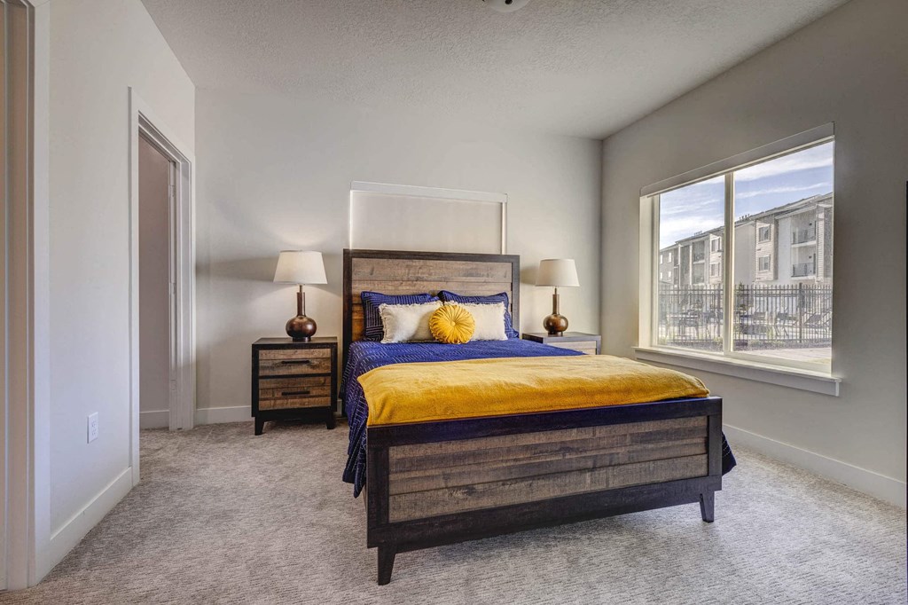 a bedroom with a bed and a window