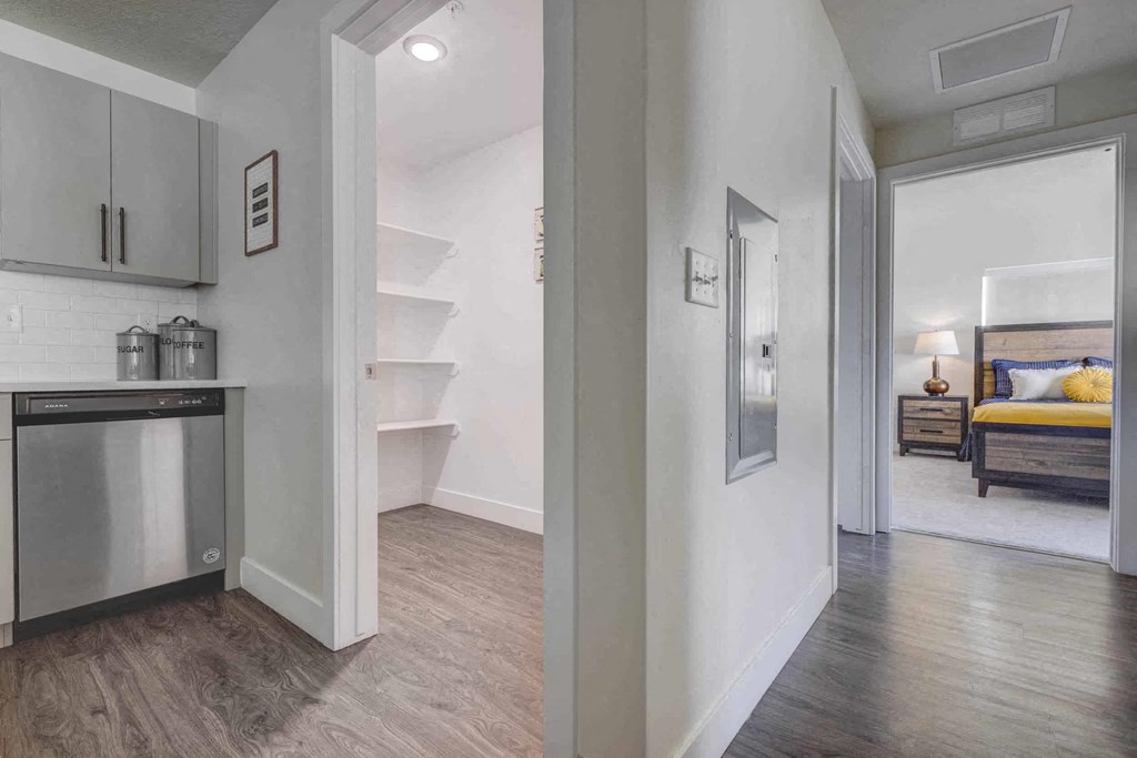 a kitchen and a living room with a door to a bedroom