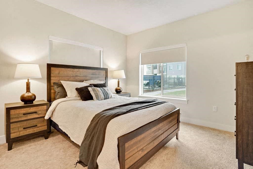 a bedroom with a bed and a window