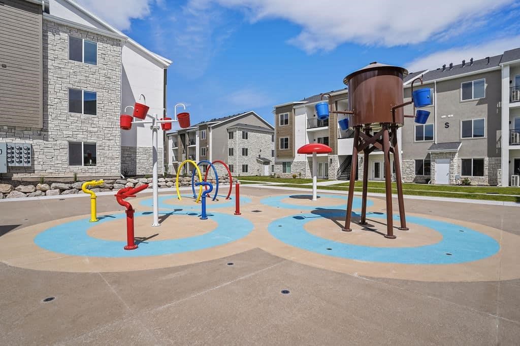 A playground with a water tower and a slide.