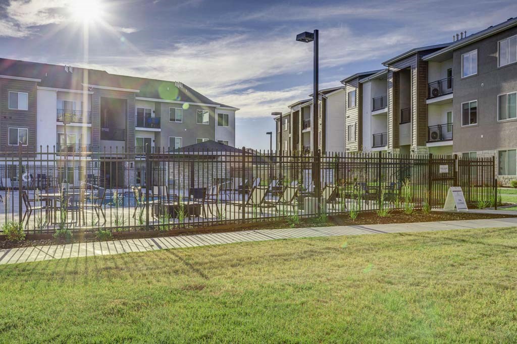A sunny day at a residential area with apartment buildings and a playground.