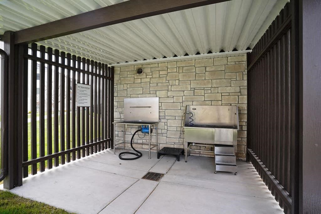 A patio with a sink and a grill.