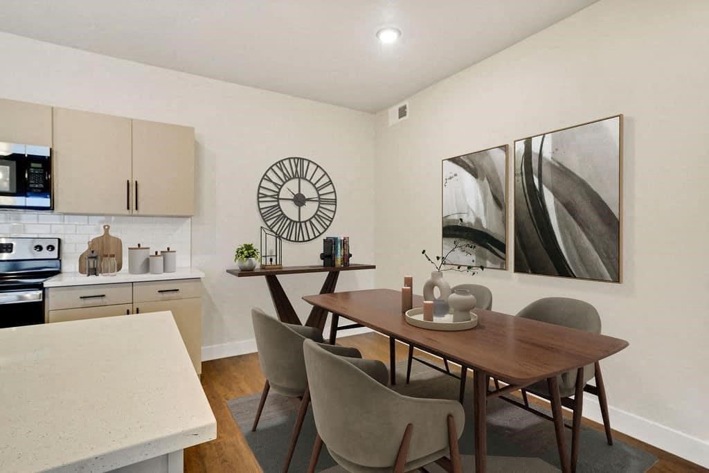A dining room with a table and chairs.