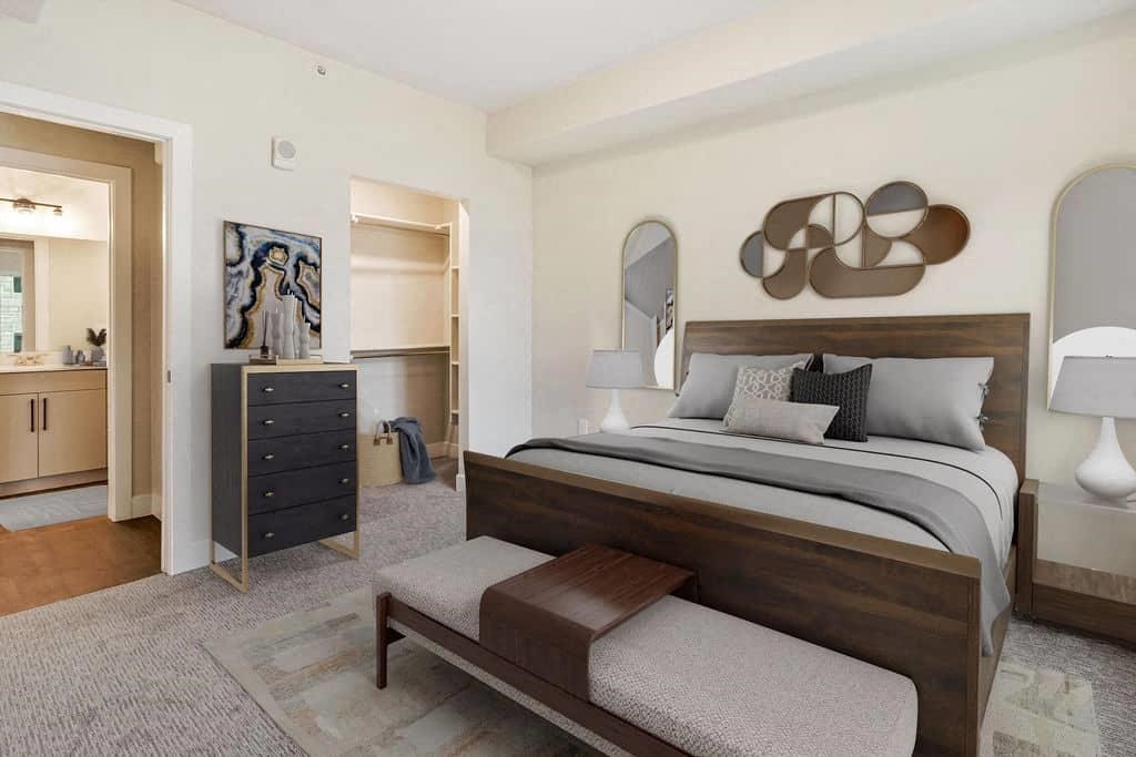 A bedroom with a large bed and a dresser.