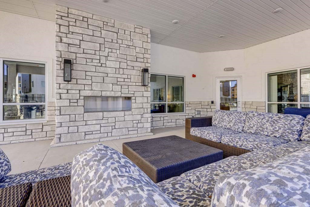 A stone fireplace is built into a wall in a living room.