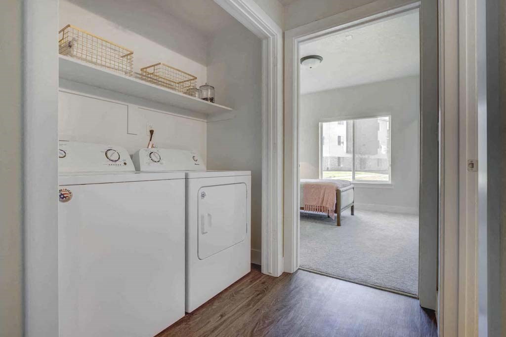 A white laundry room with a washer and dryer.