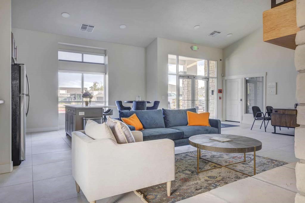 A living room with a white couch and a coffee table.
