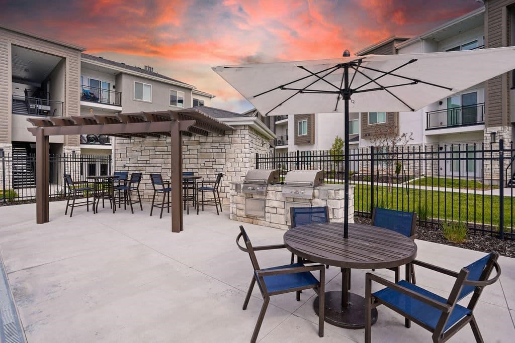 A patio with a table and chairs is set up outside a building.