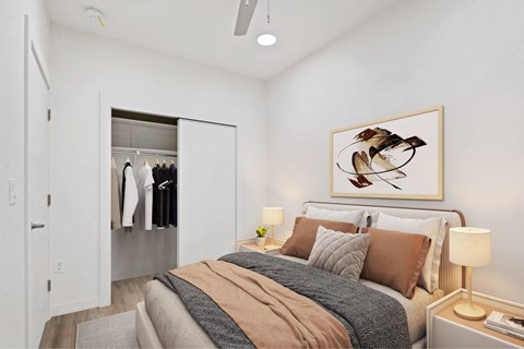 A bedroom with a bed, a nightstand, and a painting of a bird on the wall.