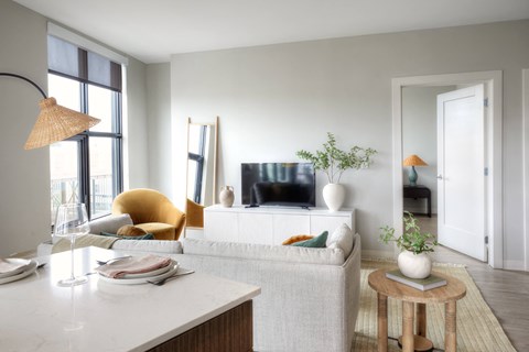 a living room with a white couch and yellow chair