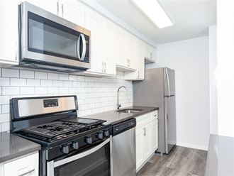a kitchen with stainless steel appliances and a microwave