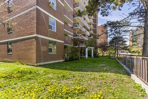 A brick building with a green lawn in front.