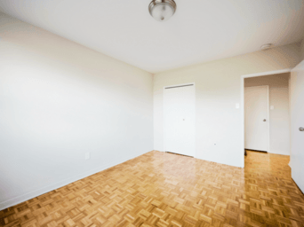 A room with a wooden floor and white walls.