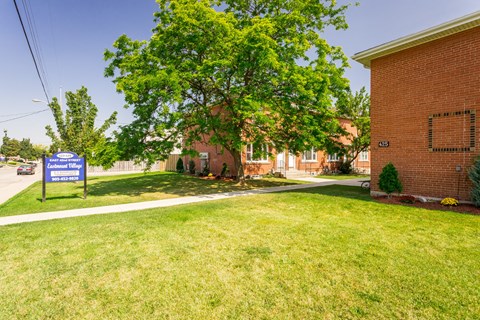 A sign in front of a building that says "Public Library".