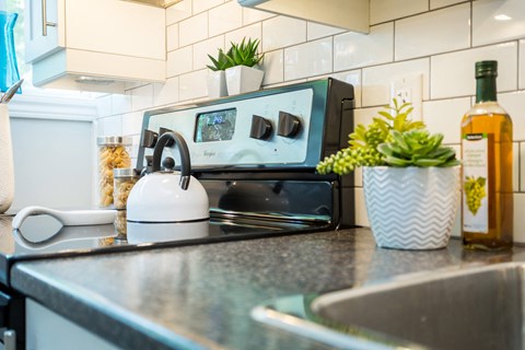 A modern kitchen with a stove top and a microwave.