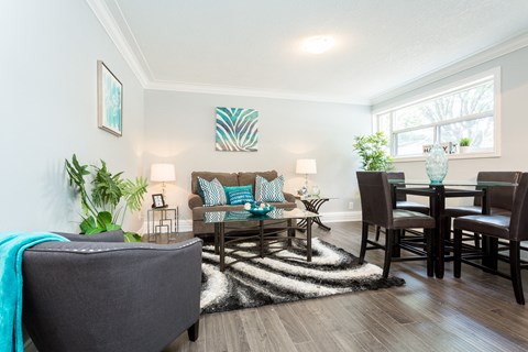 A living room with a grey couch and a wooden table.