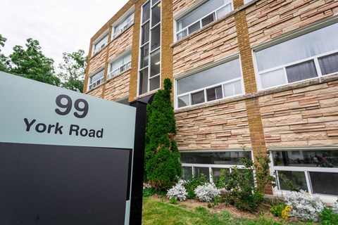 A building with the number 99 on a sign in front of it.